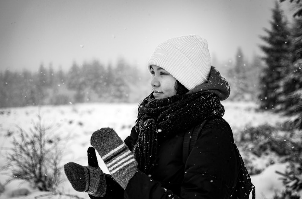 a person holding a baby in the snow