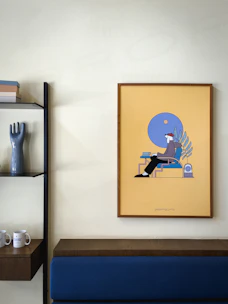 Close-up of a modern abstract poster framed elegantly on a minimalist shelf.