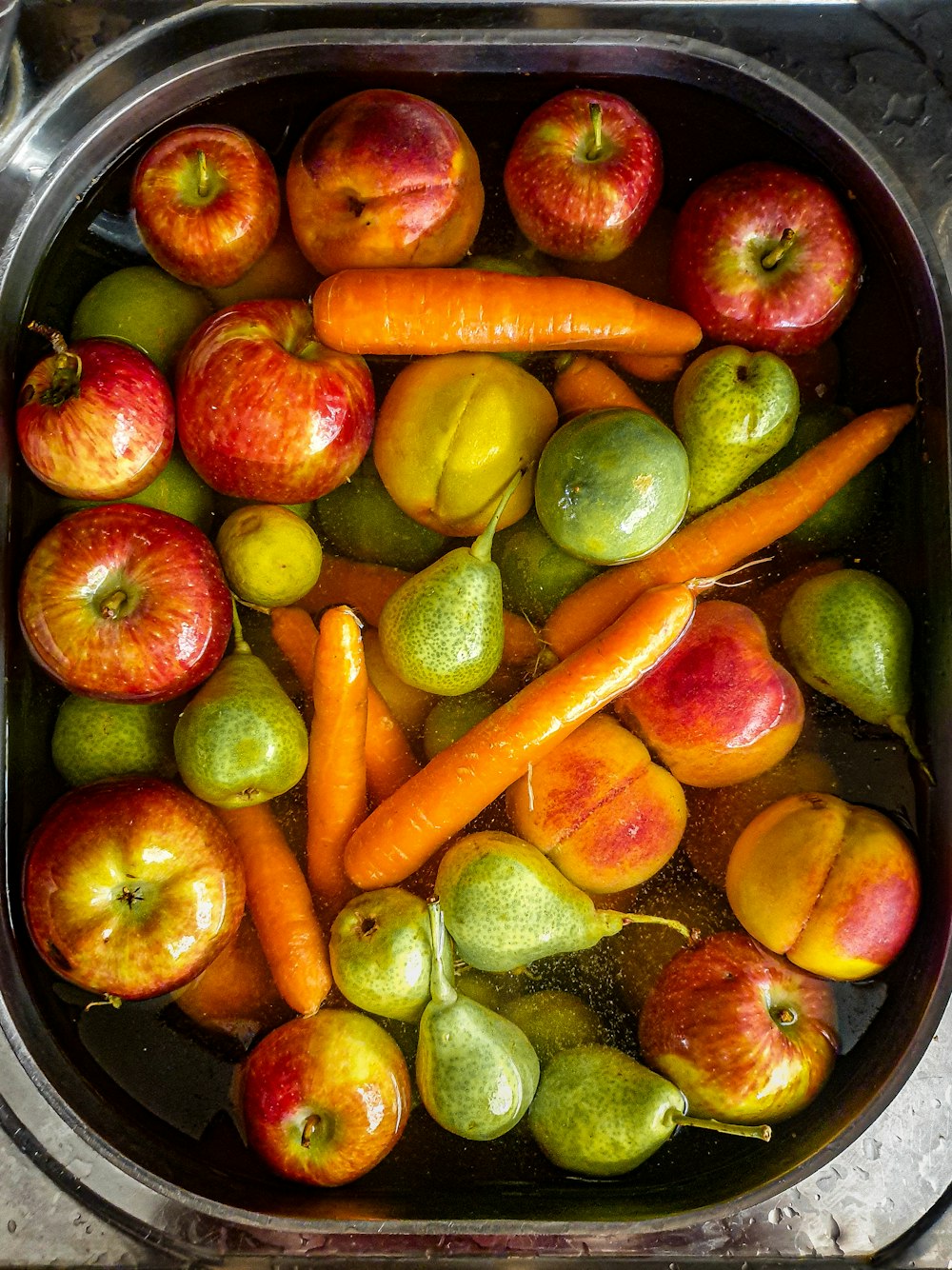 a bowl of apples and carrots