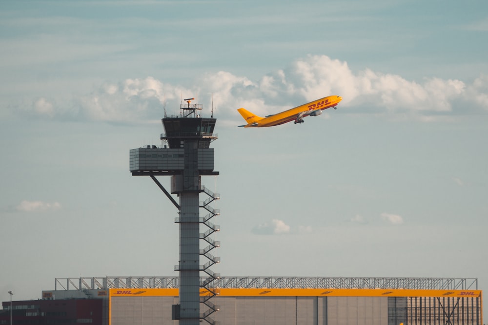 an airplane flying over a tower