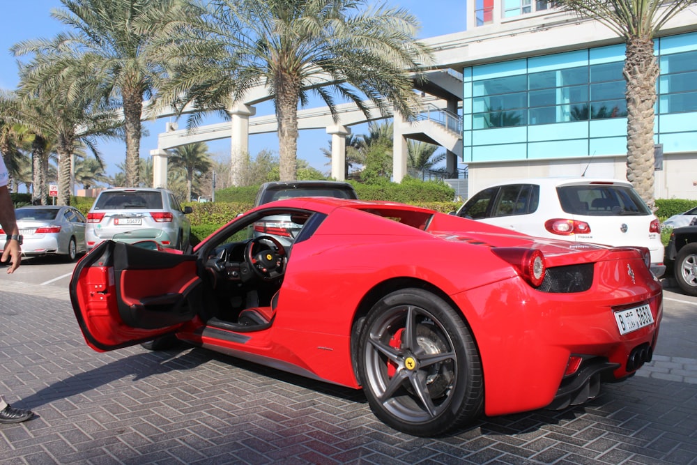 a red sports car parked on a brick road