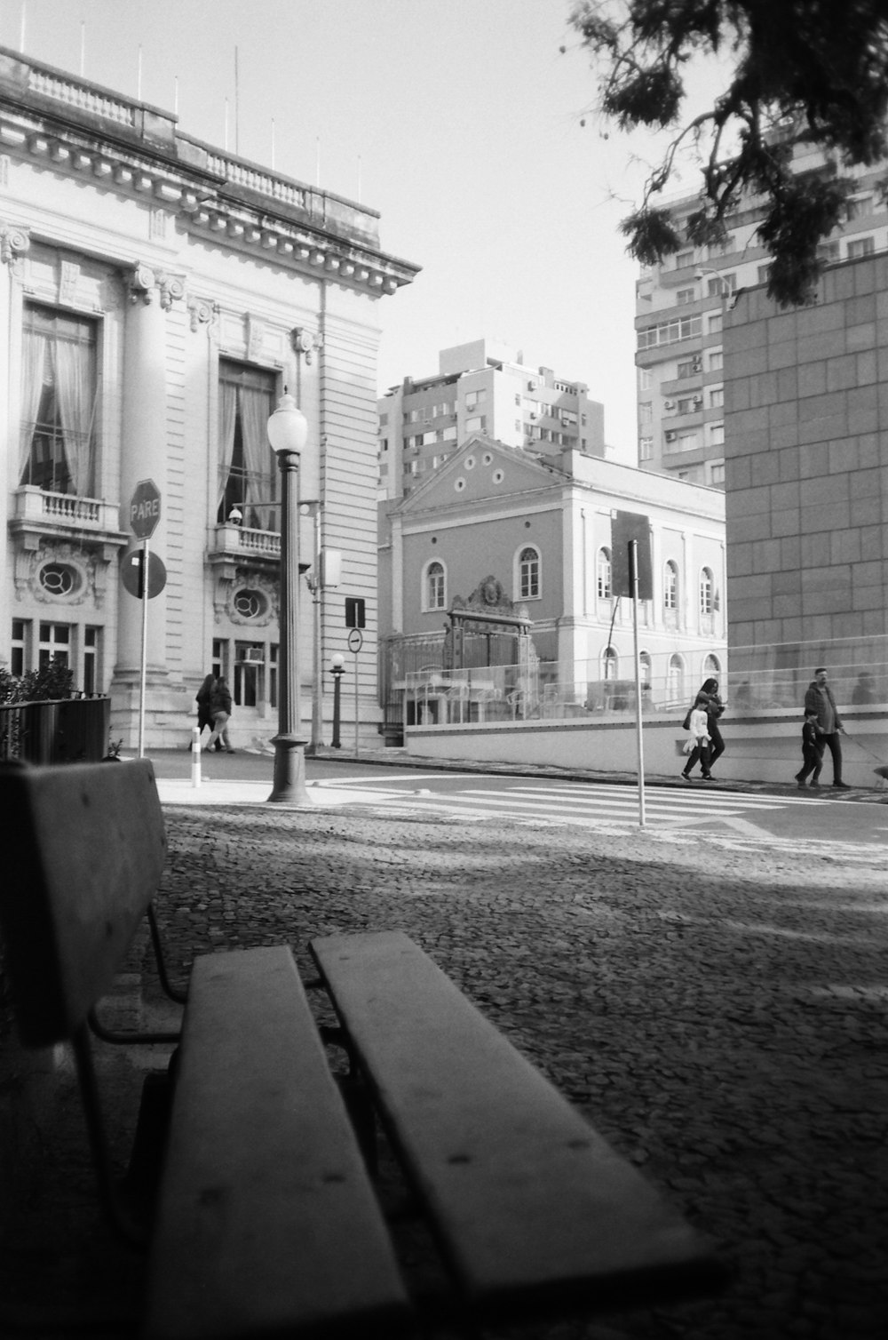 a couple of people walk down a sidewalk