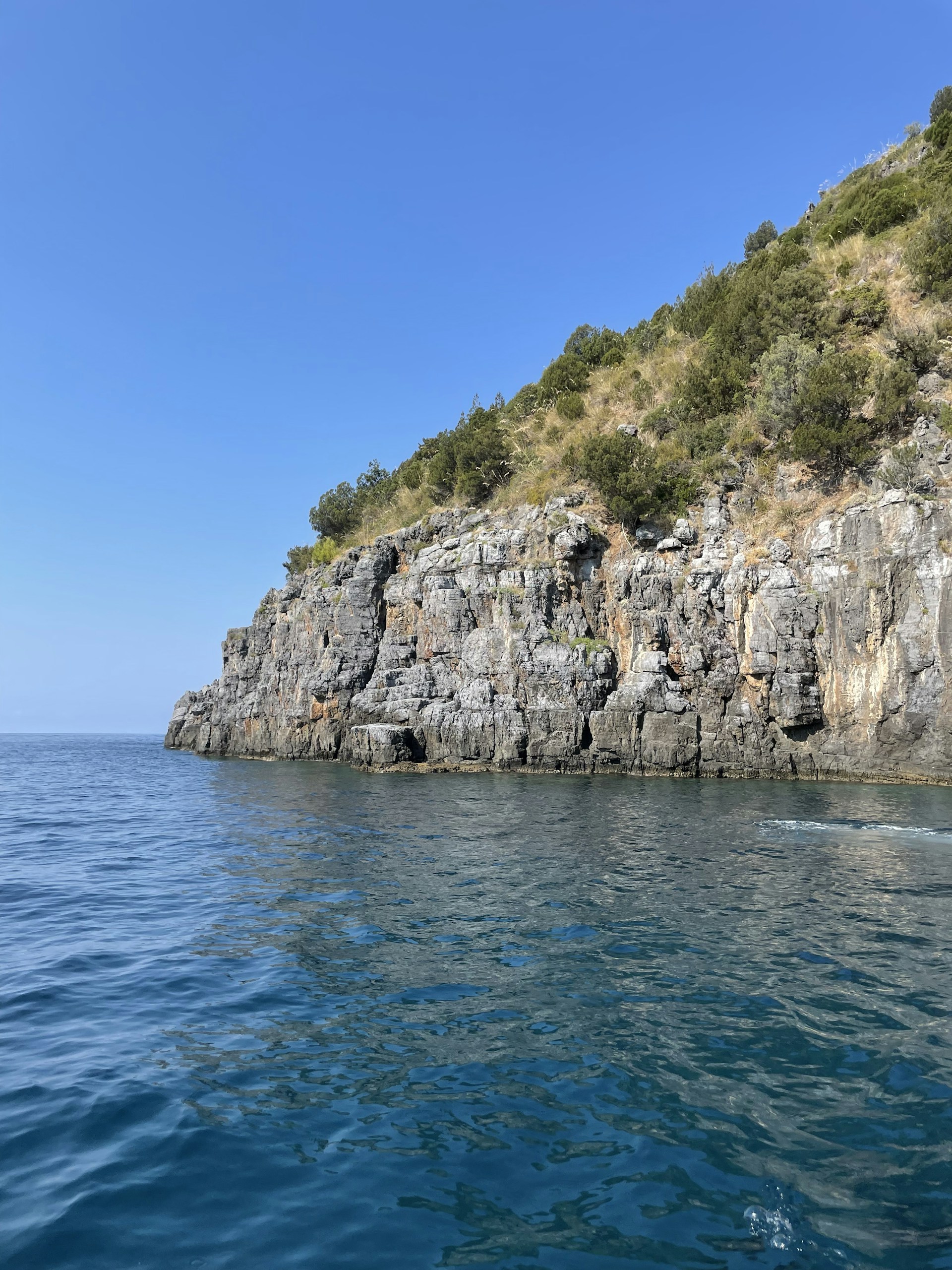 a cliff with a body of water below
