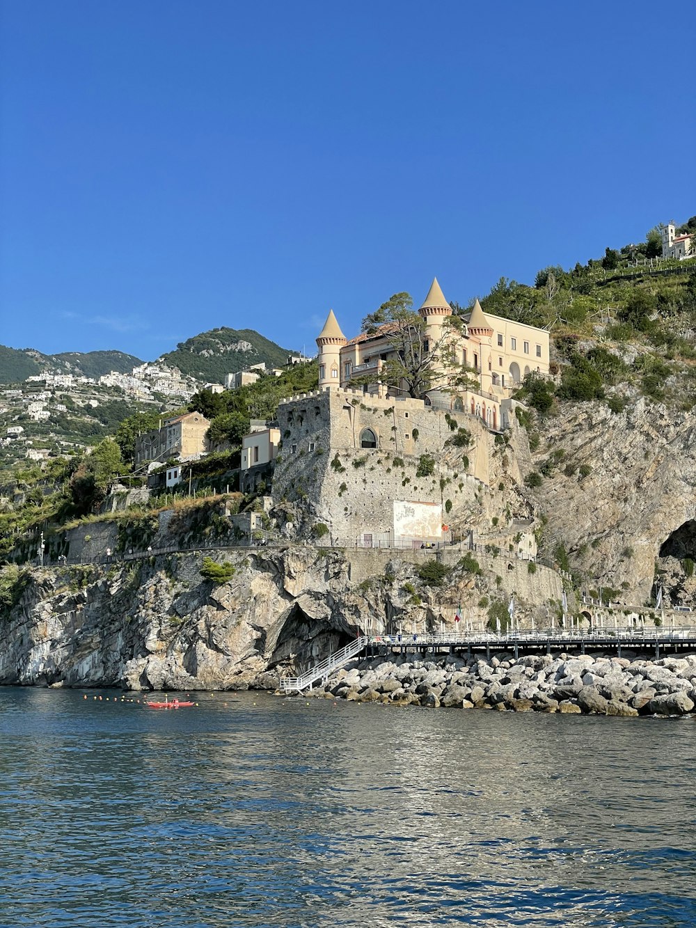 a castle on a cliff over water