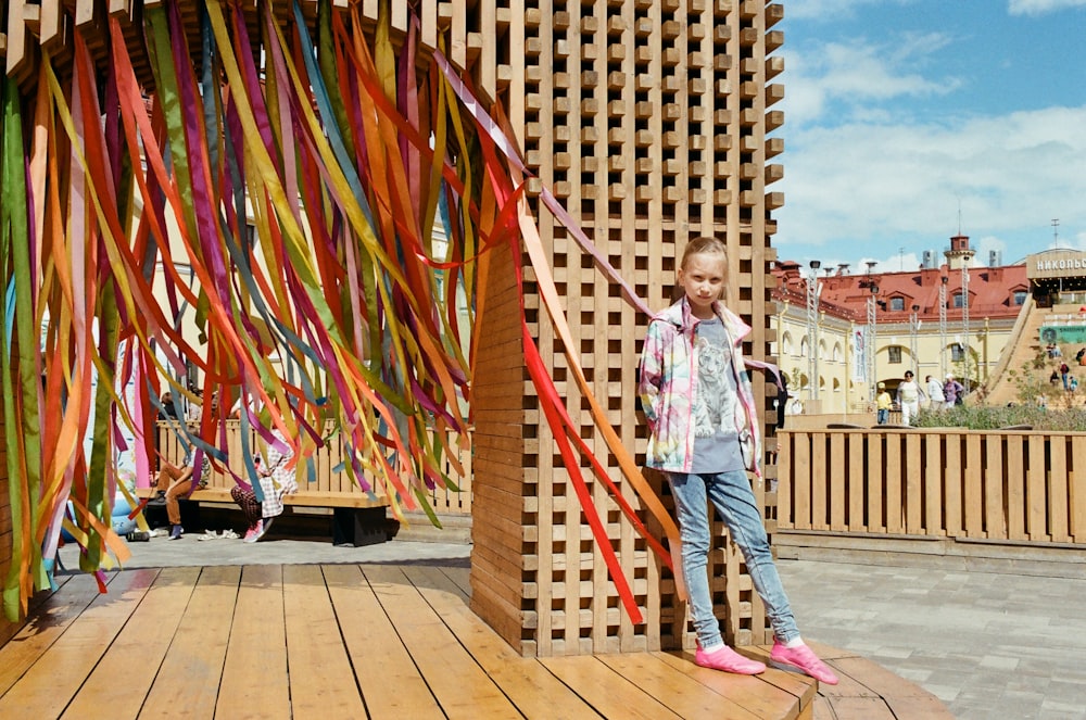 a girl standing next to a large sculpture