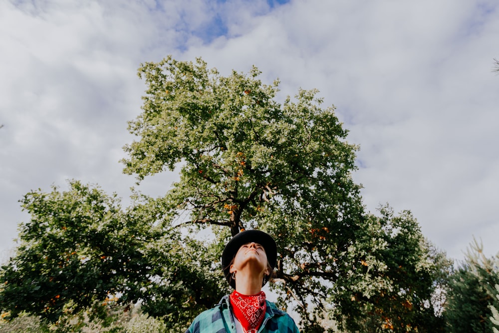 a man standing in front of a tree