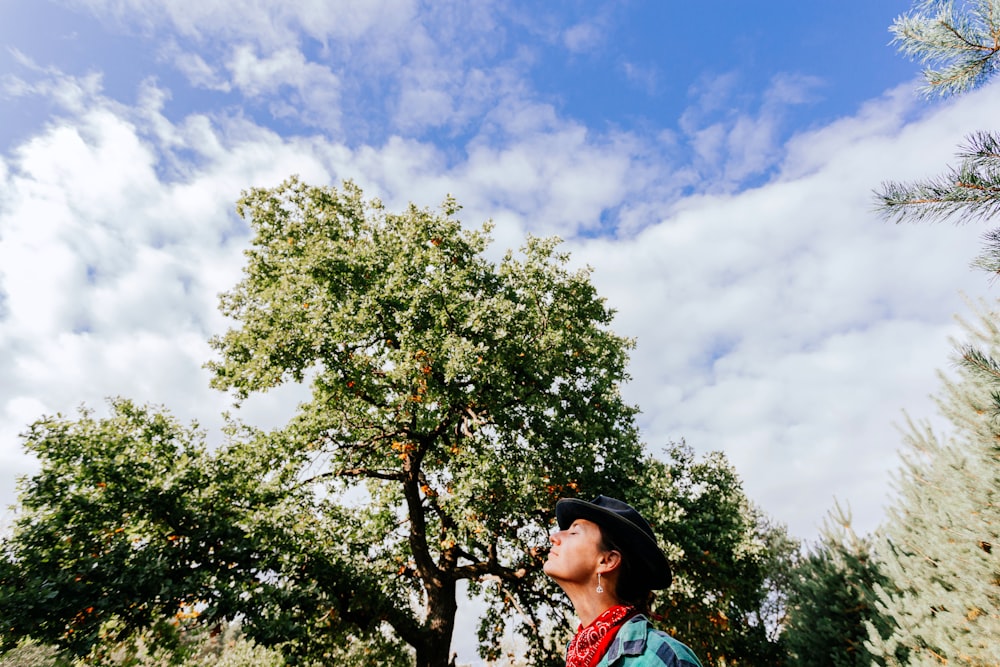 a man standing next to a tree