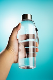 a hand holding a bottle of water