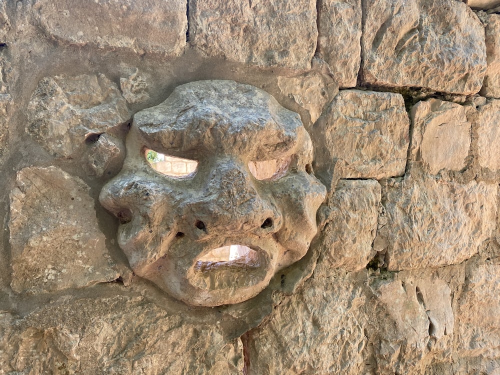 a carved face on a rock