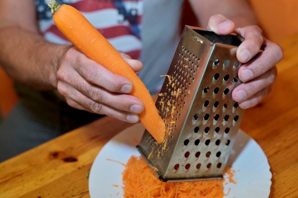 a person cutting a piece of bread