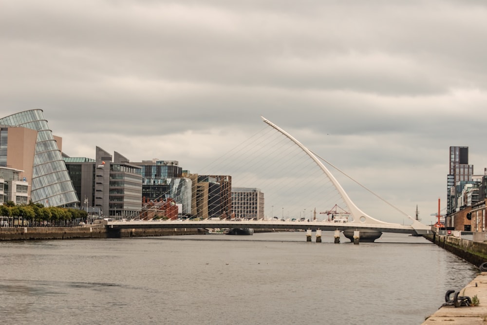 a bridge over a river with buildings in the background