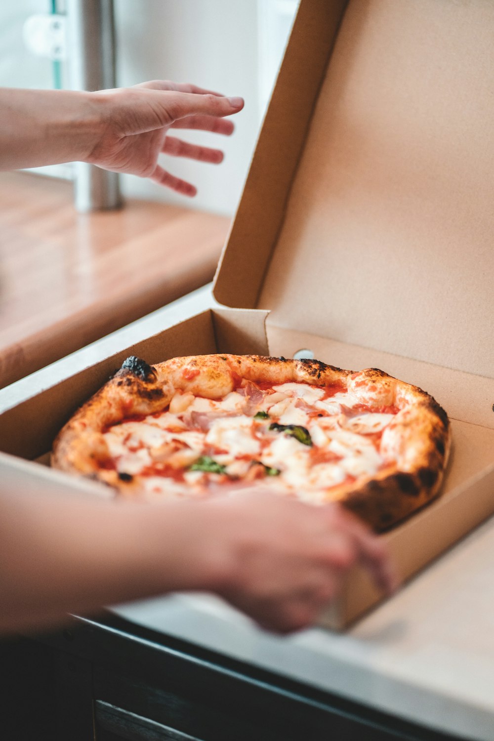 a person holding a pizza