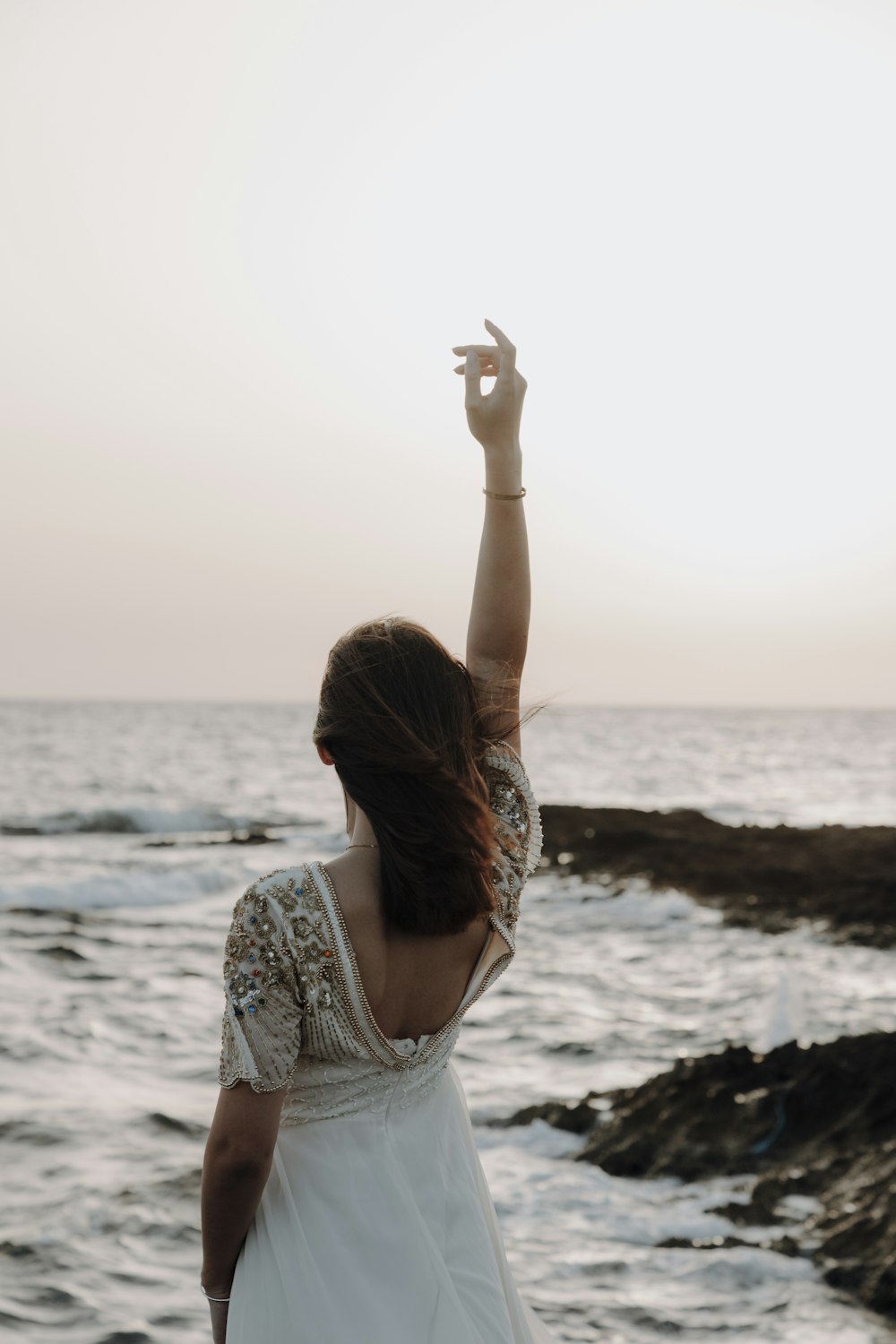 a person standing on a rocky beach