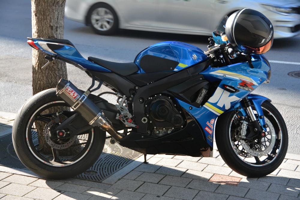 a motorcycle parked next to a tree