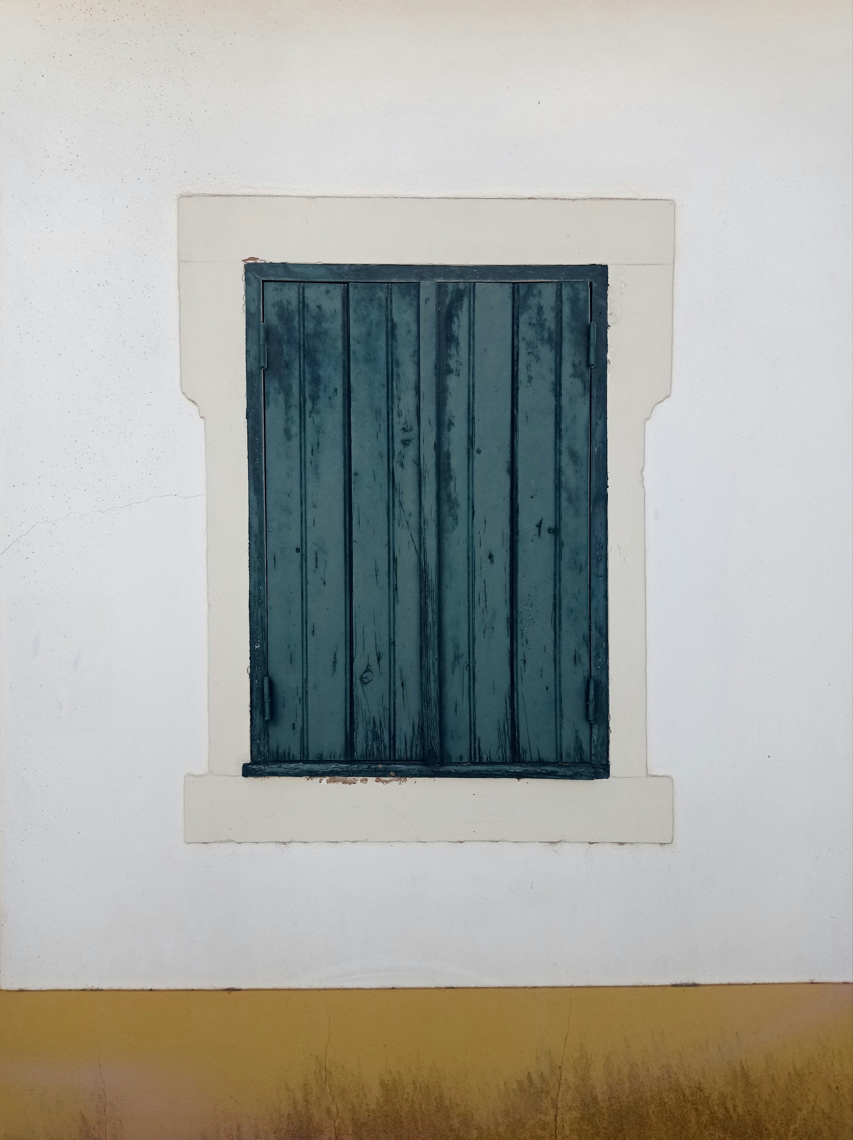 a window in a white wall