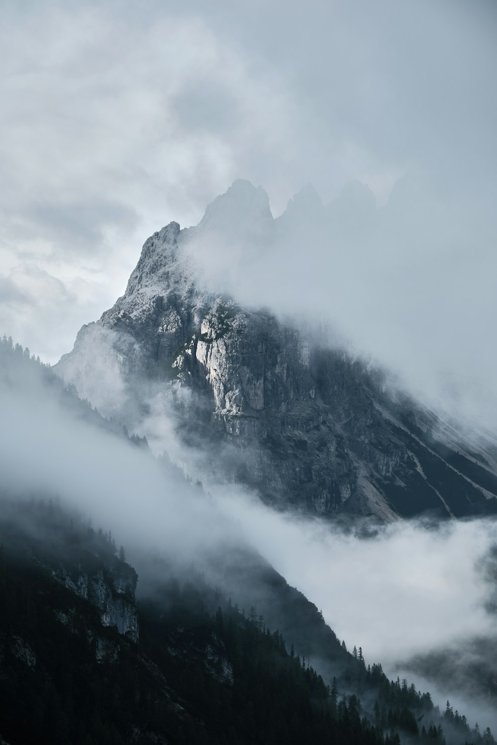 a mountain with clouds around it