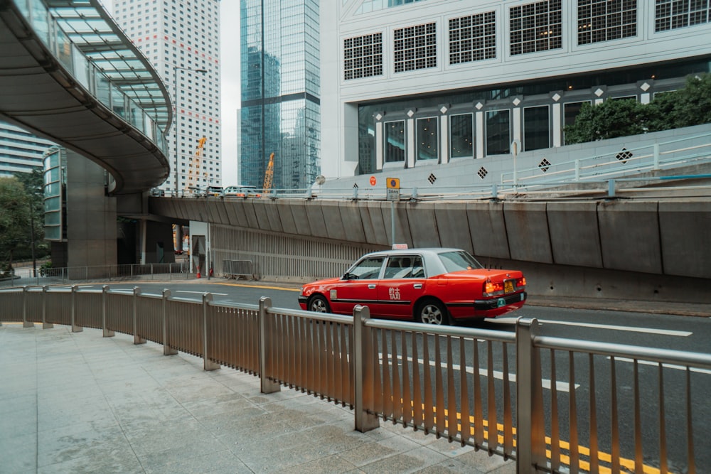 a red car driving on a road