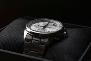 a silver watch on a person's wrist