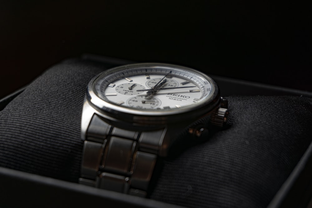 a silver watch on a person's wrist
