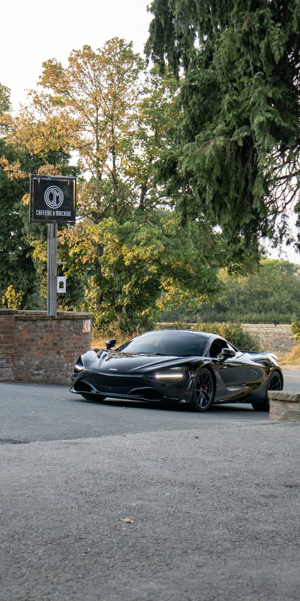 a black sports car parked on the side of a road