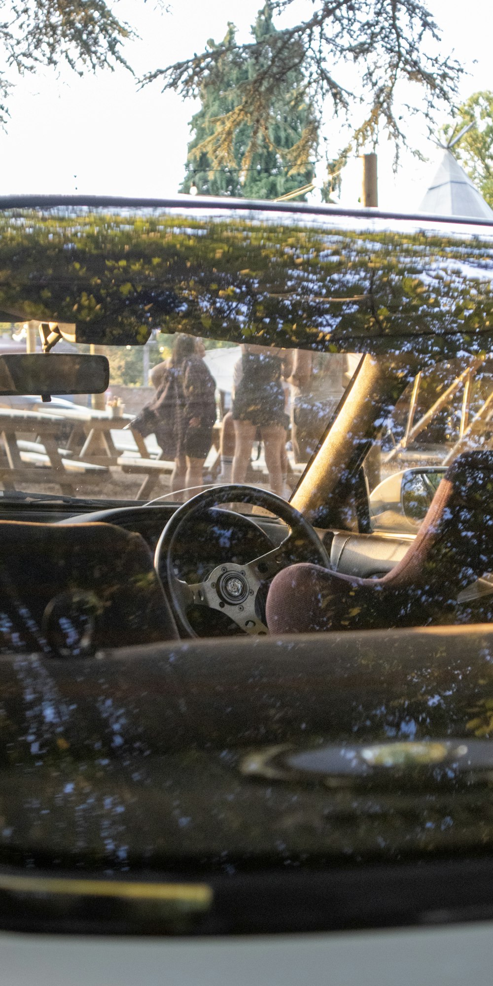 a car with a reflection of people in it