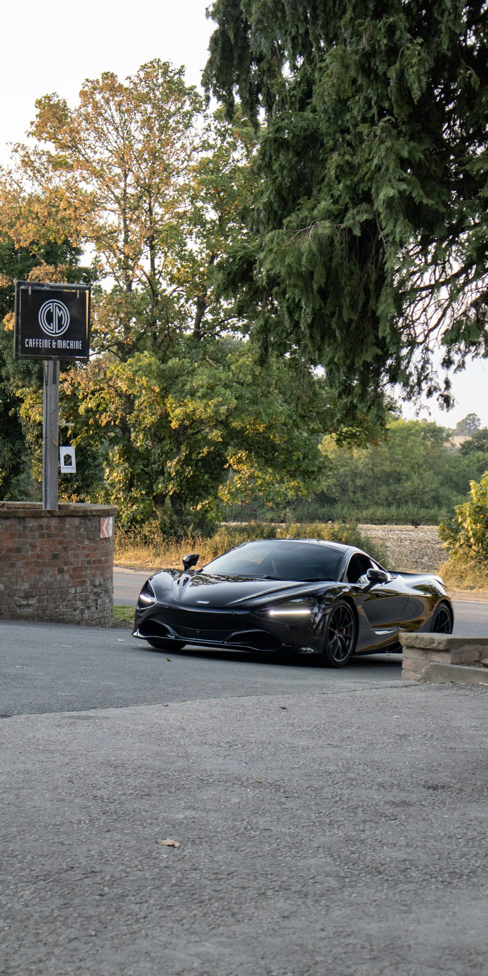 a black sports car parked on the side of a road