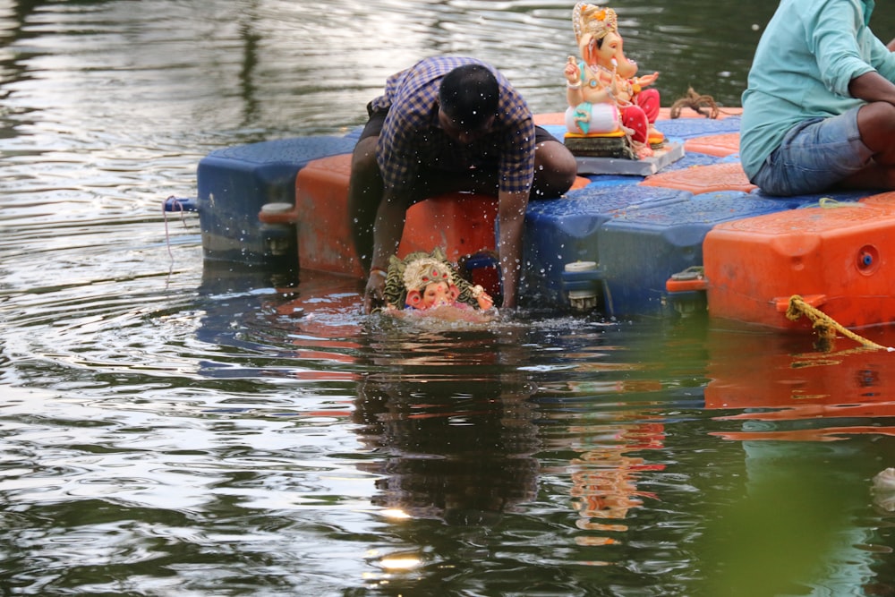 a person and a child on a boat in the water