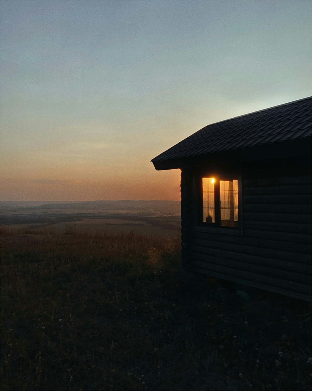 a house with a sunset in the background