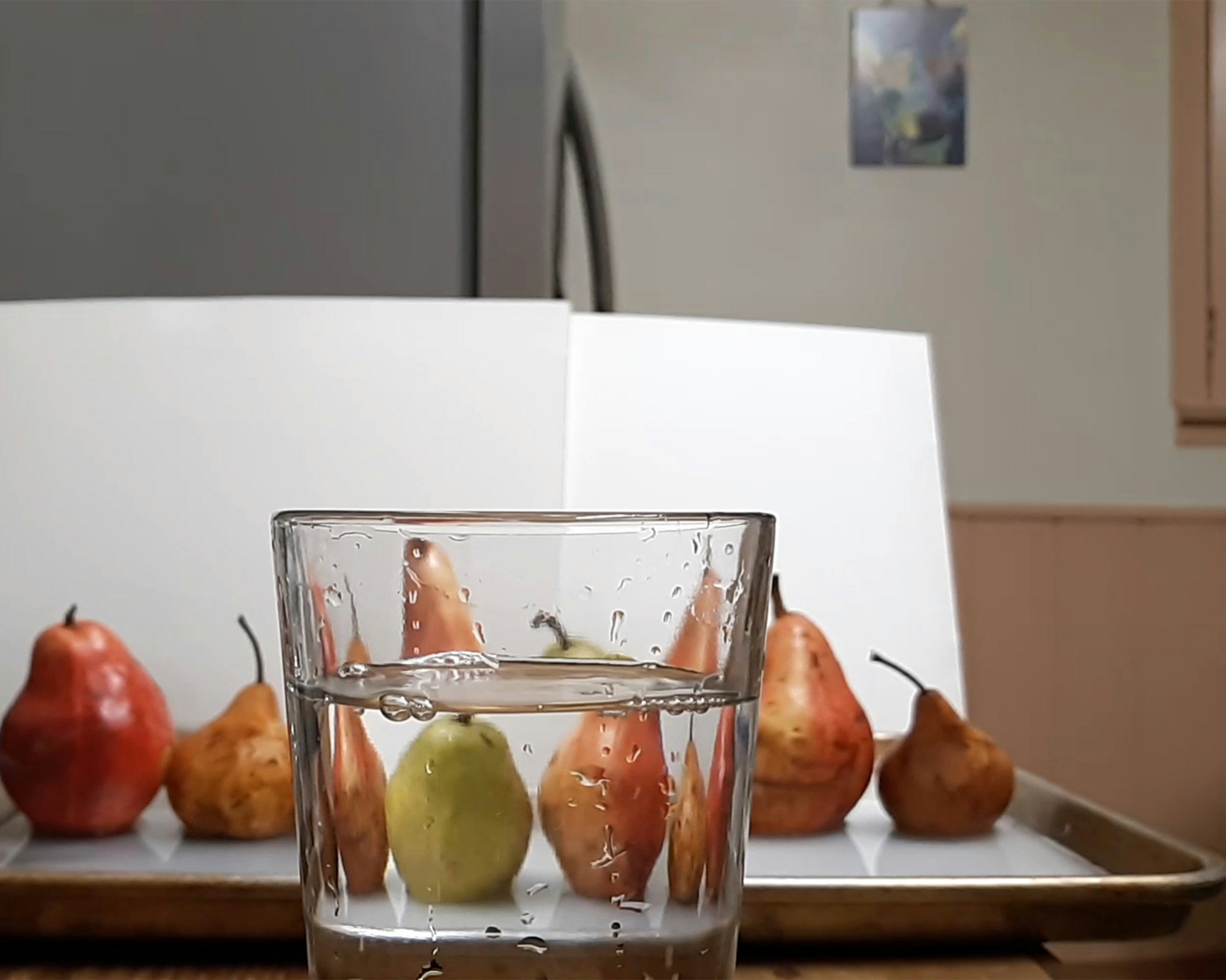 a glass of water with fruit in it