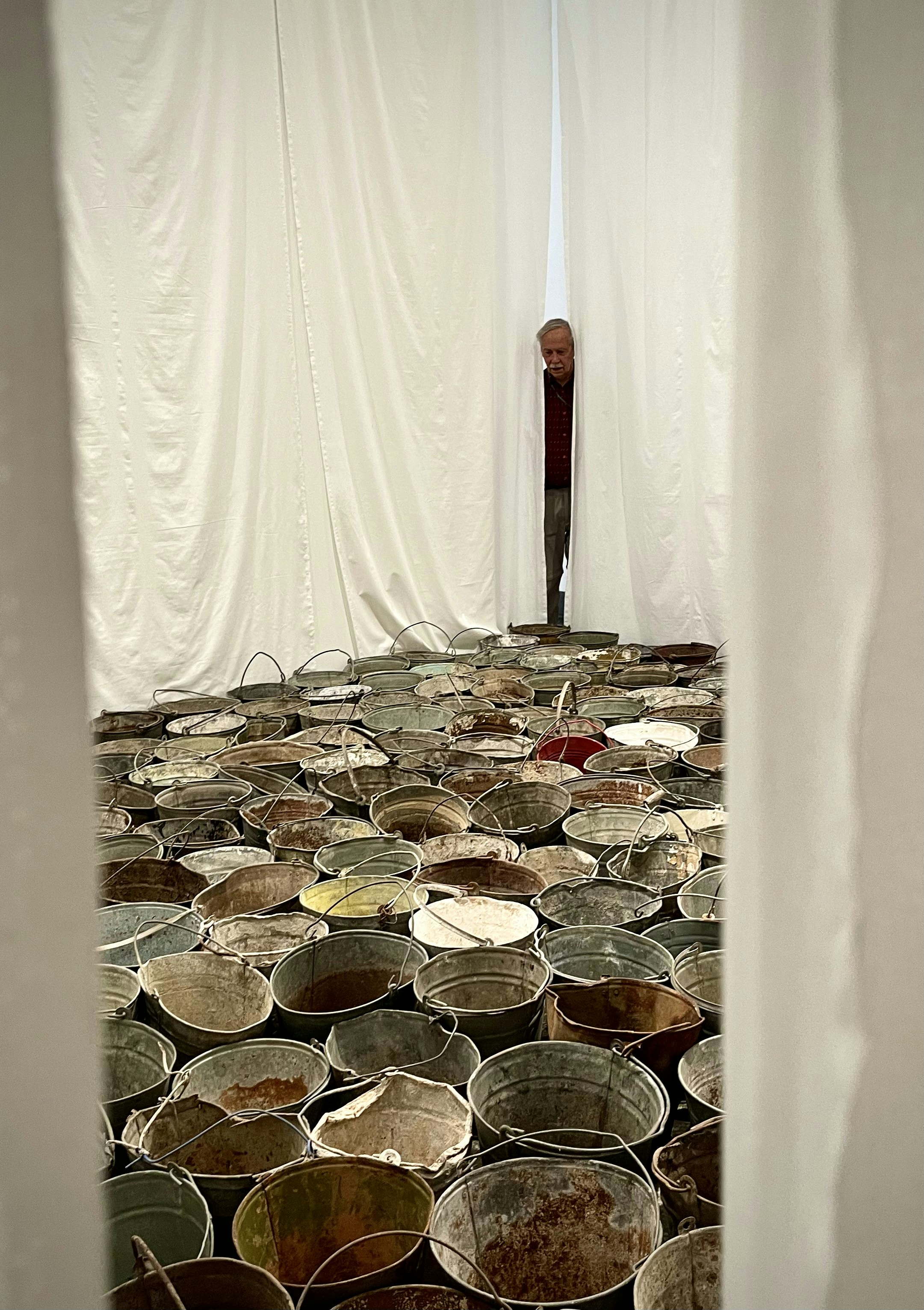 a person standing behind a stack of coins