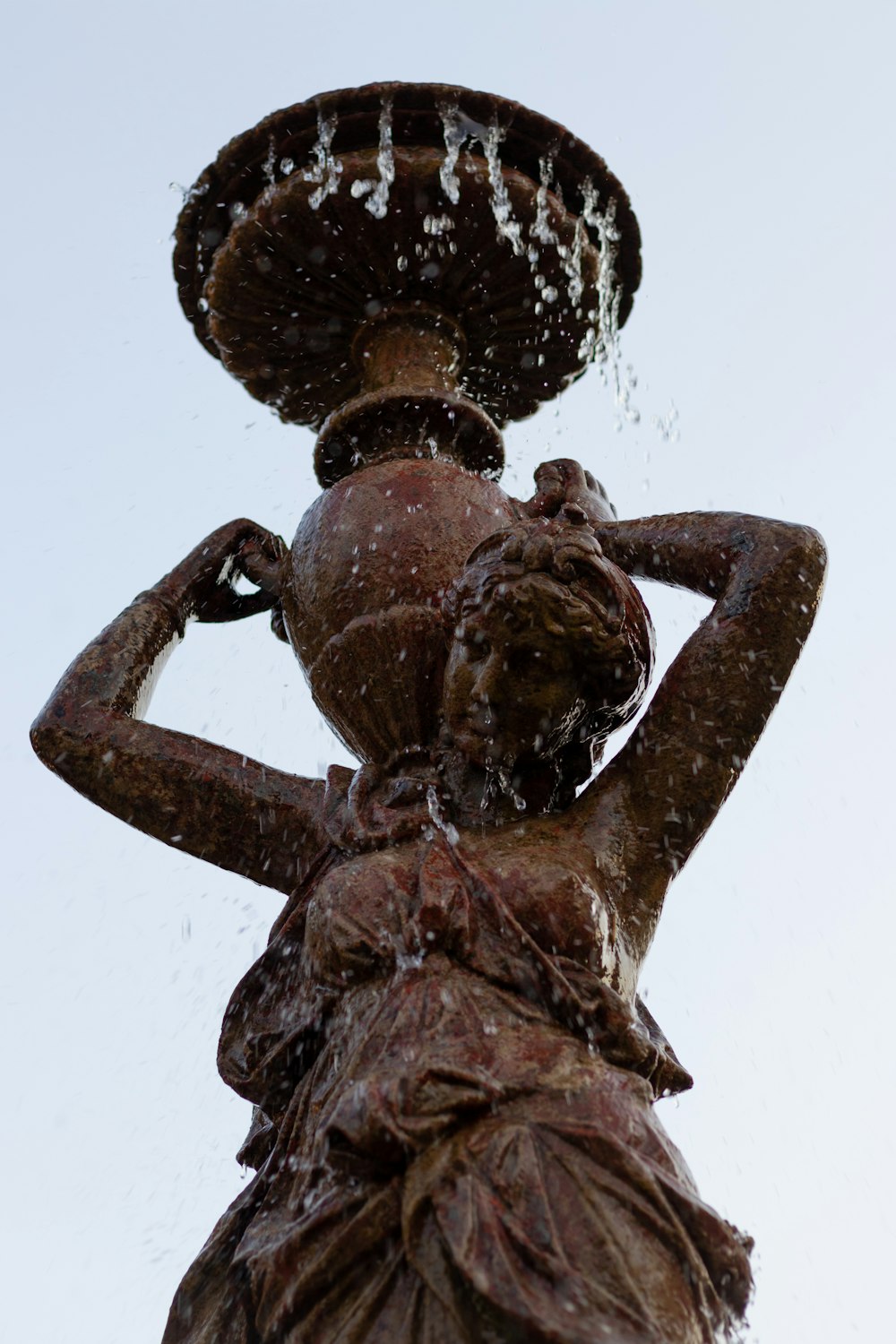 a statue of a person holding a staff