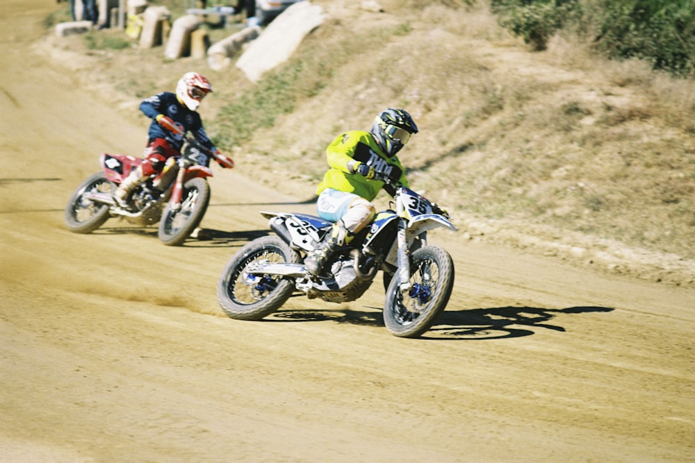 two people riding motorcycles