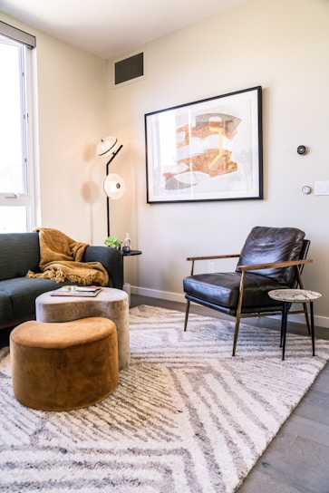 A cozy living room corner featuring warm lighting, decorative cushions, and minimalist wall art.