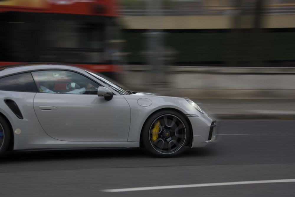 a white car driving on a road