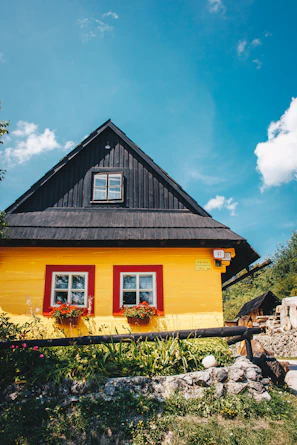 Exterior of a cozy house freshly painted with warm earthy tones under a sunny sky