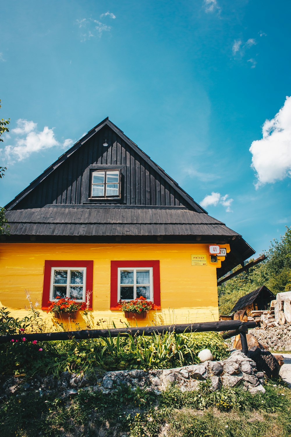 a yellow house with a red roof
