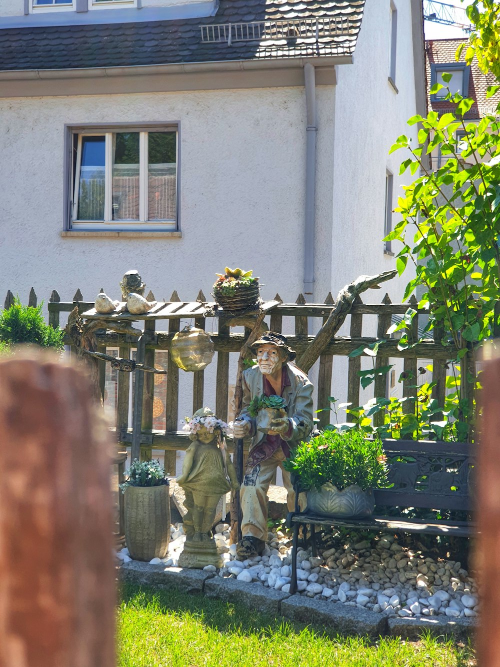 a group of statues outside a house