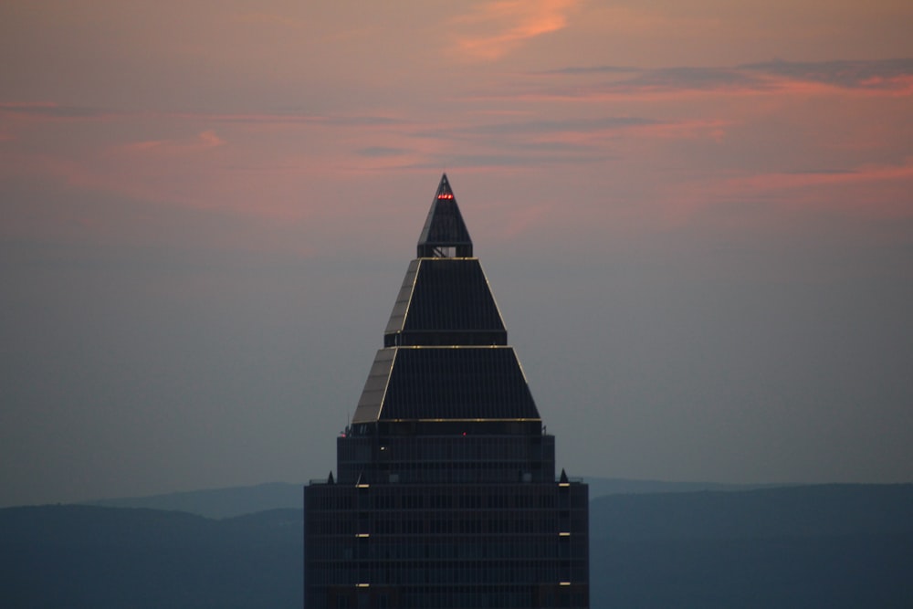 a tall building with a red sky