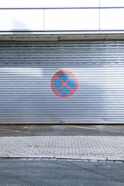 a red and blue logo on a metal wall