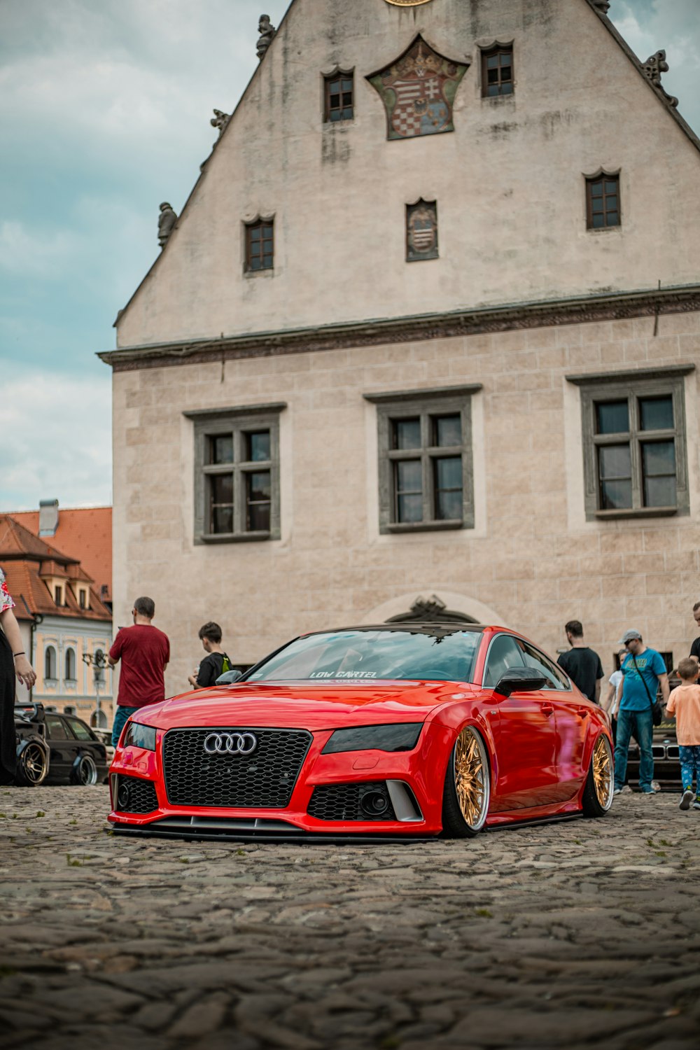 a red sports car parked in front of a building