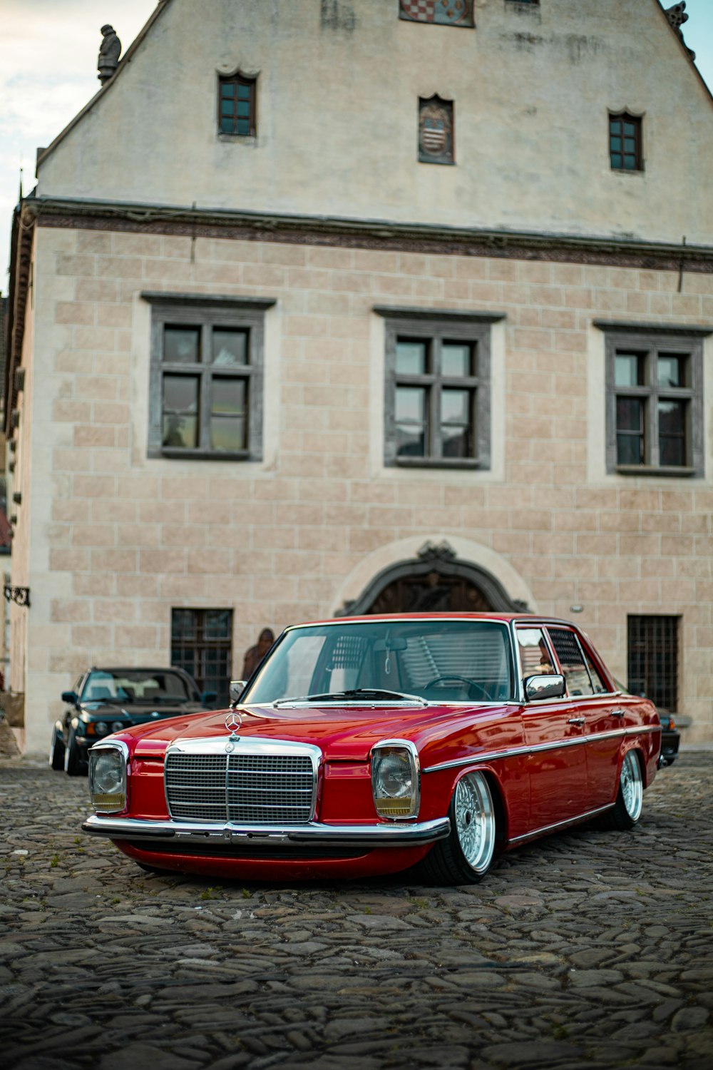 a red car parked in front of a building