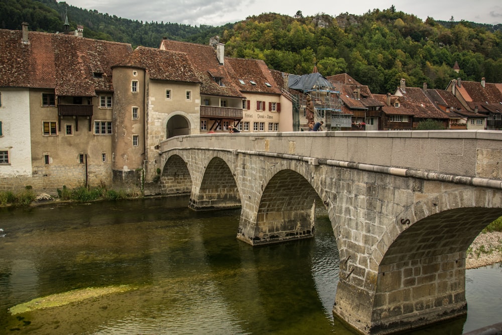 a bridge over a river with buildings on the side