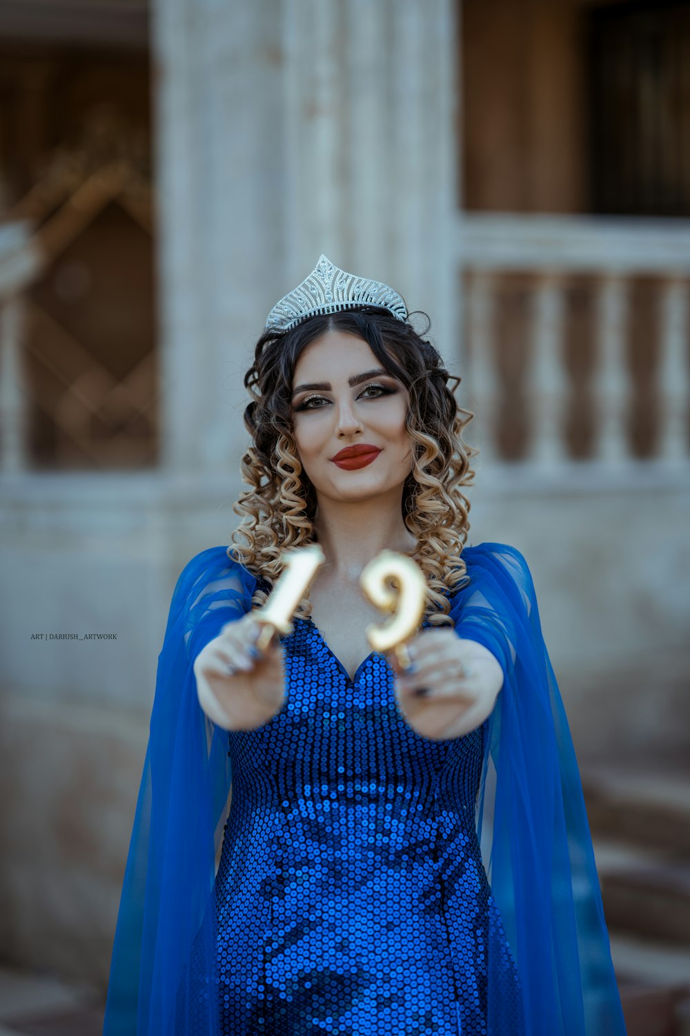 a person in a blue dress holding ice cream cones