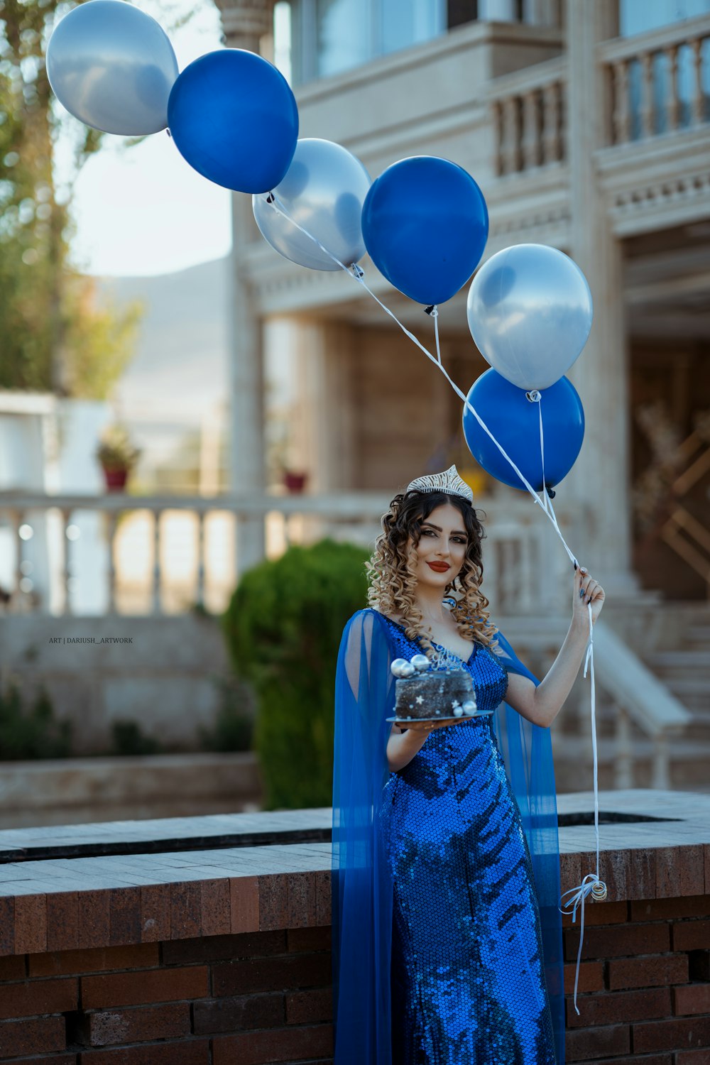 a person holding a bunch of balloons