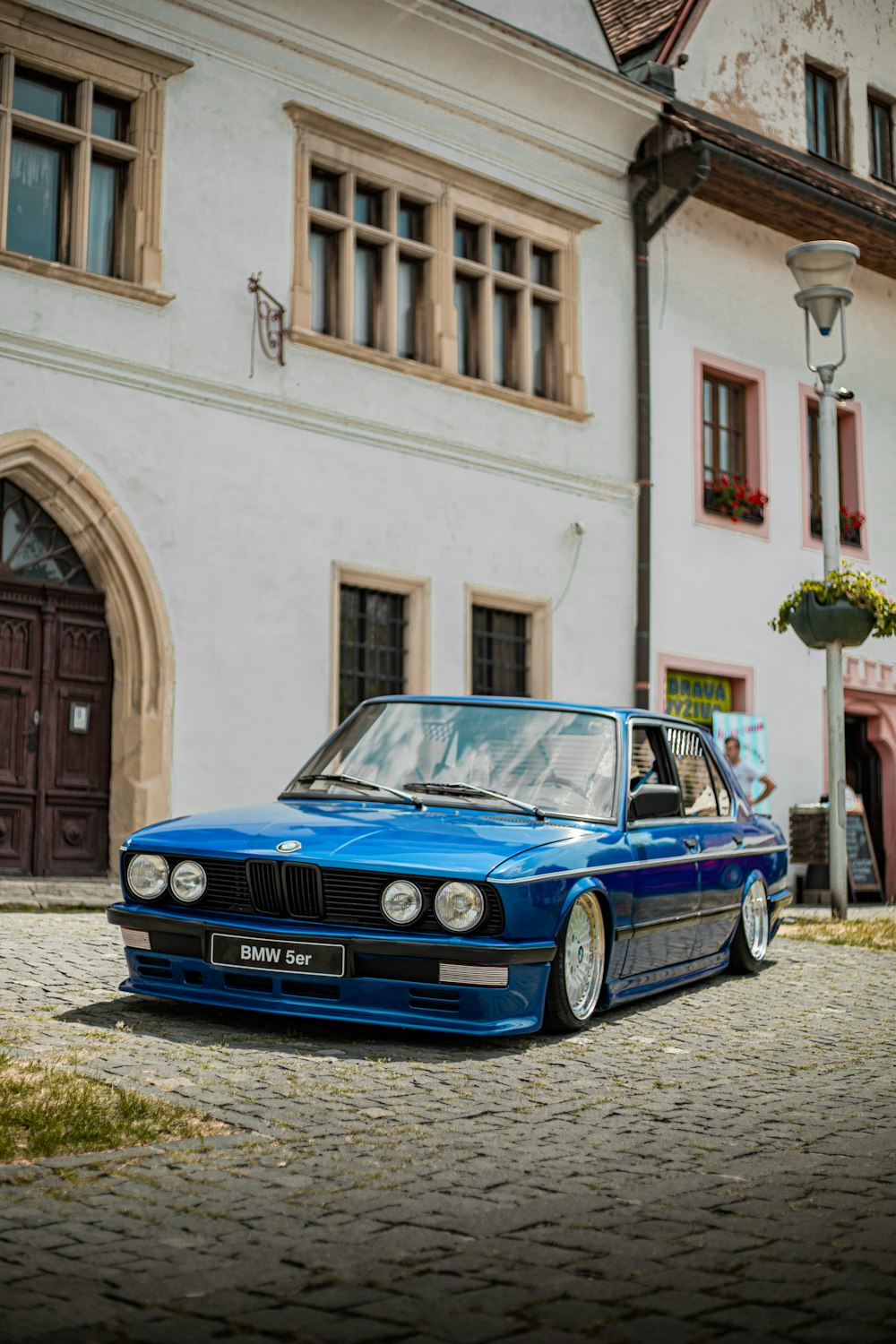 a blue car parked in front of a building