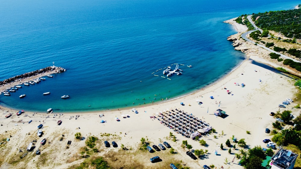 a beach with boats and people