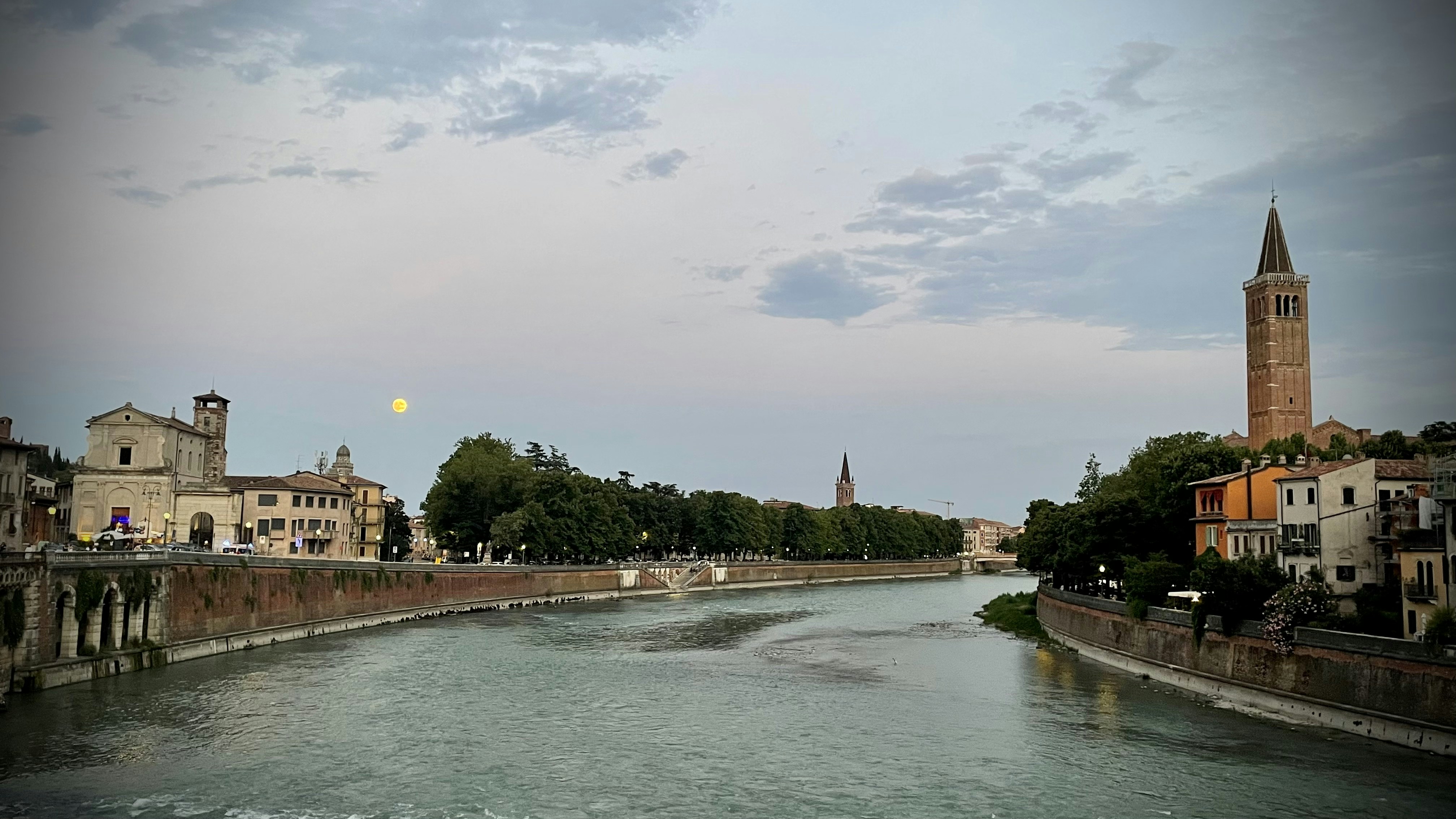 a river with a bridge and buildings along it
