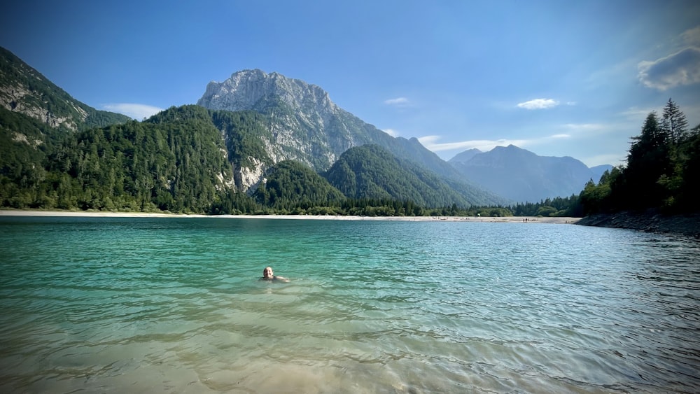 a person swimming in a lake