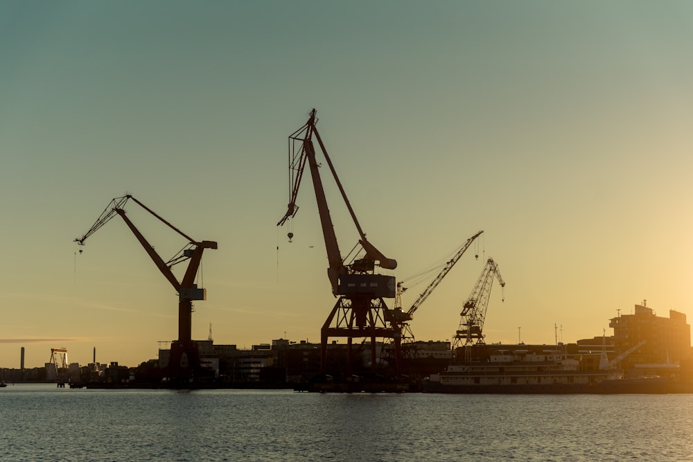 a group of cranes on a dock