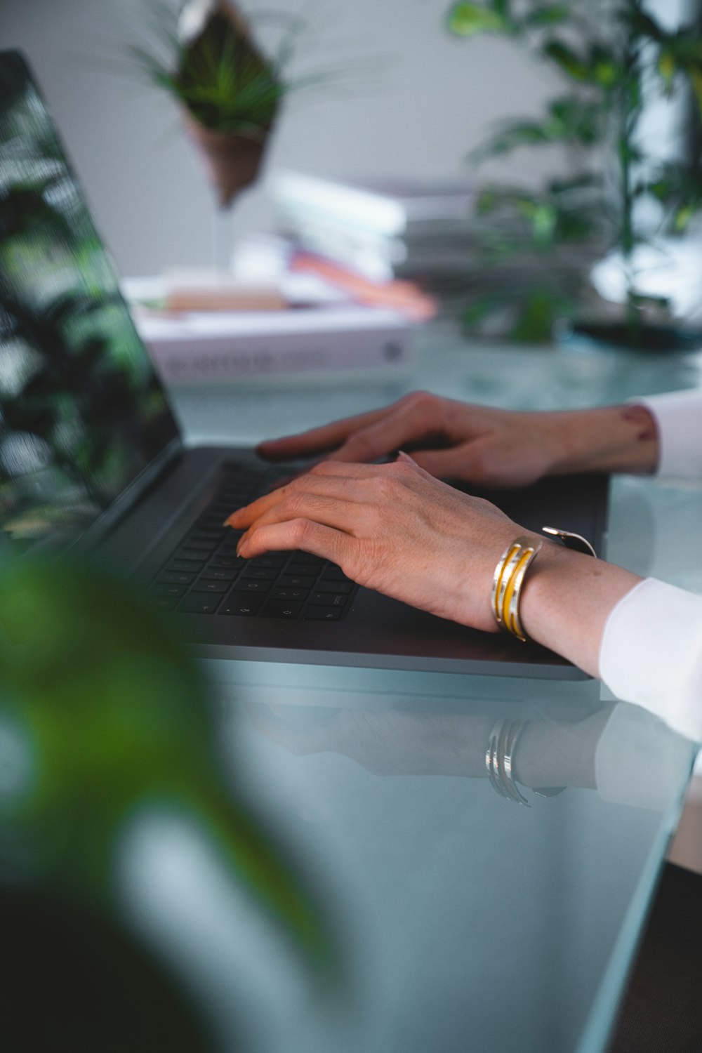 a close-up of hands typing on a laptop